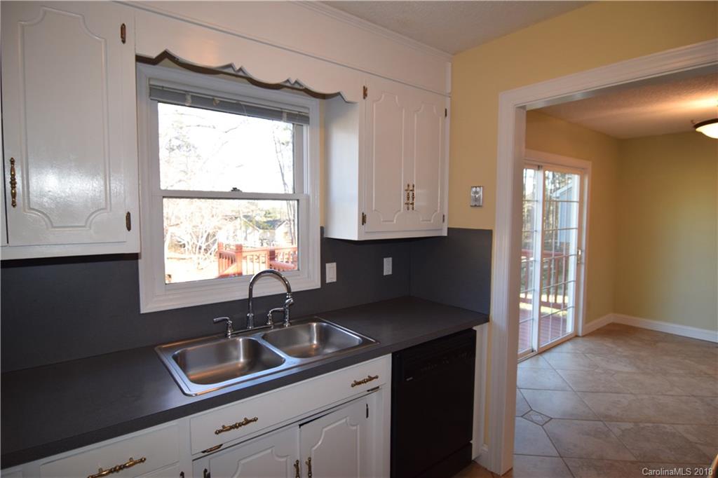 8667 Unity Church Road Denver, NC 28037 - Photo 6 of 23 a kitchen with granite countertop a sink and a window
