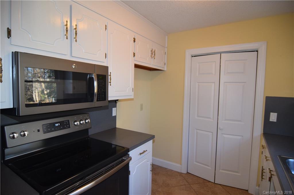 8667 Unity Church Road Denver, NC 28037 - Photo 7 of 23 a kitchen with microwave and cabinets
