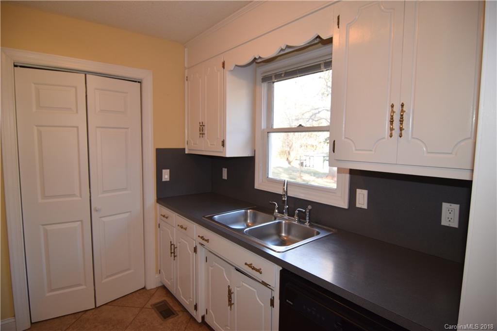 8667 Unity Church Road Denver, NC 28037 - Photo 8 of 23 a kitchen with stainless steel appliances granite countertop white cabinets and window