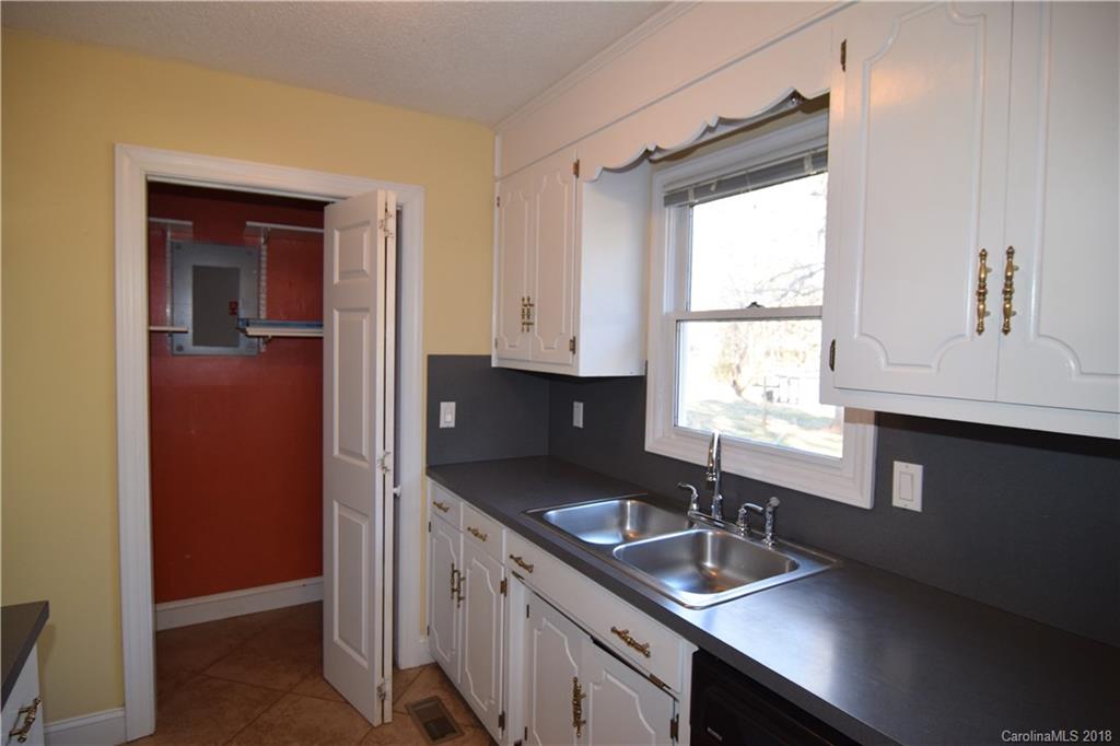 8667 Unity Church Road Denver, NC 28037 - Photo 9 of 23 a kitchen with granite countertop a sink and a window