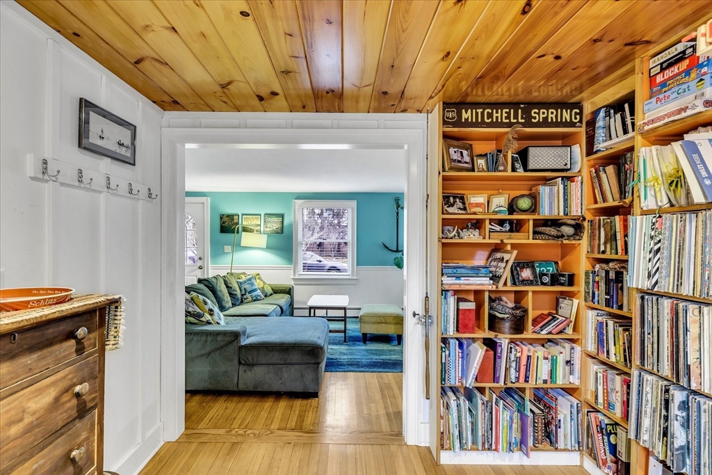 34 Weir Road Yarmouth, MA 02675 - Photo 15 of 39 a living room with lots of furniture and a book shelf