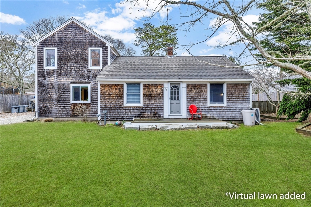 34 Weir Road Yarmouth, MA 02675 - Photo 2 of 39 a front view of house with yard and green space