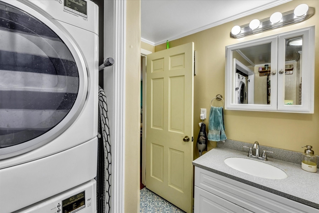 34 Weir Road Yarmouth, MA 02675 - Photo 21 of 39 a bathroom with a granite countertop sink a mirror a vanity and shower