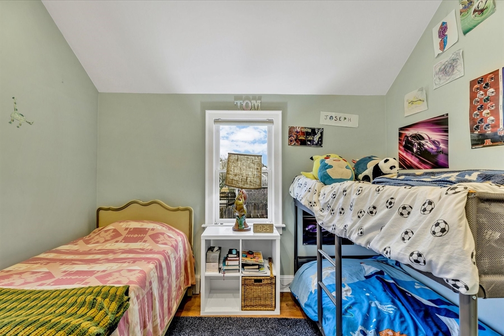 34 Weir Road Yarmouth, MA 02675 - Photo 24 of 39 a bed sitting in a bedroom next to a window with furniture