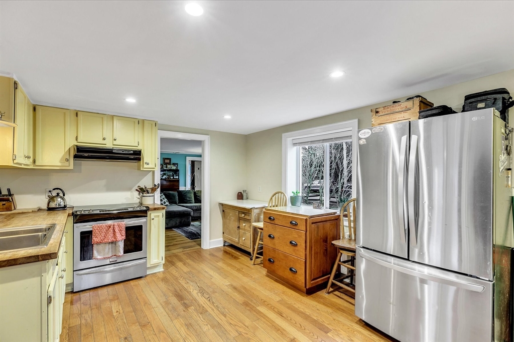 34 Weir Road Yarmouth, MA 02675 - Photo 8 of 39 a kitchen with stainless steel appliances granite countertop a refrigerator a stove and a wooden floors