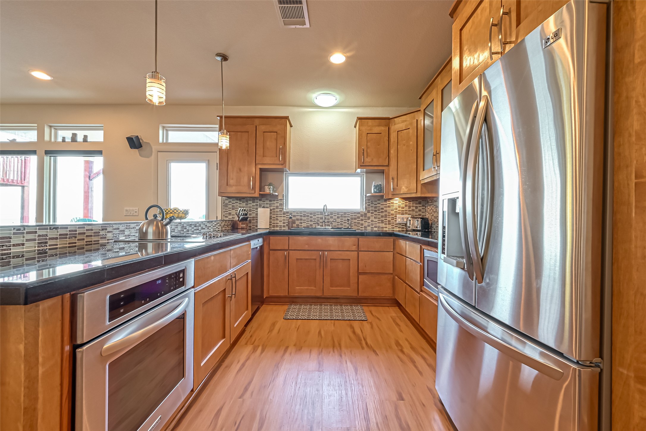 2102 Todville Road, Unit 9 Seabrook, TX 77586 - Photo 12 of 45 a kitchen with stainless steel appliances granite countertop a refrigerator a sink dishwasher a stove and white countertops with wooden floor