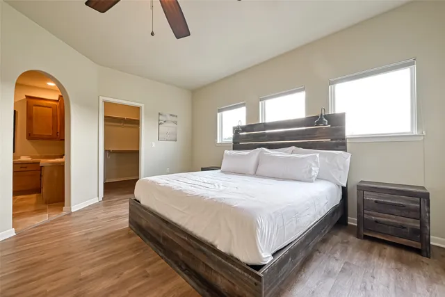 a bedroom with a bed and wooden floor