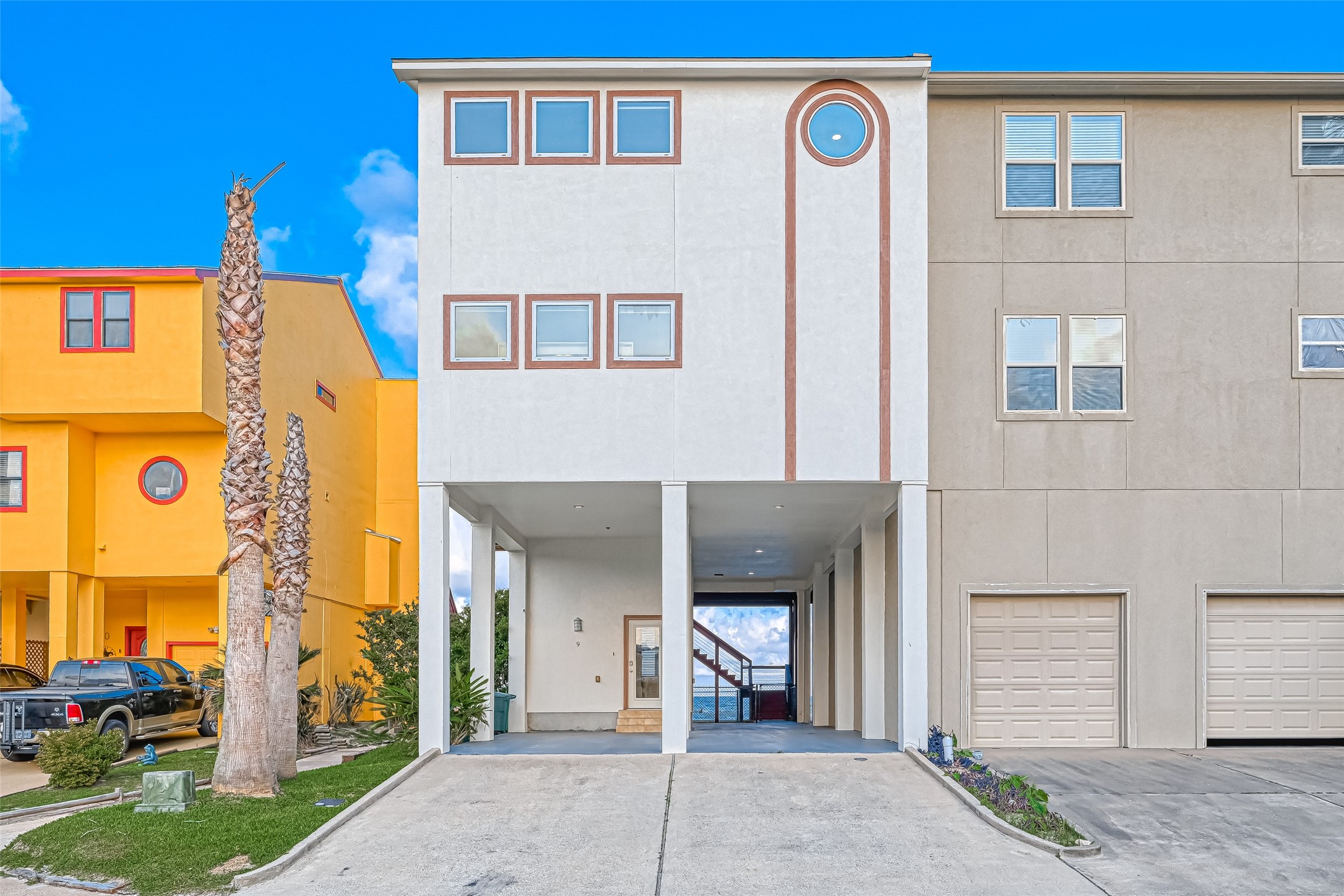 2102 Todville Road, Unit 9 Seabrook, TX 77586 - Photo 2 of 45 a front view of a house with a yard and garage