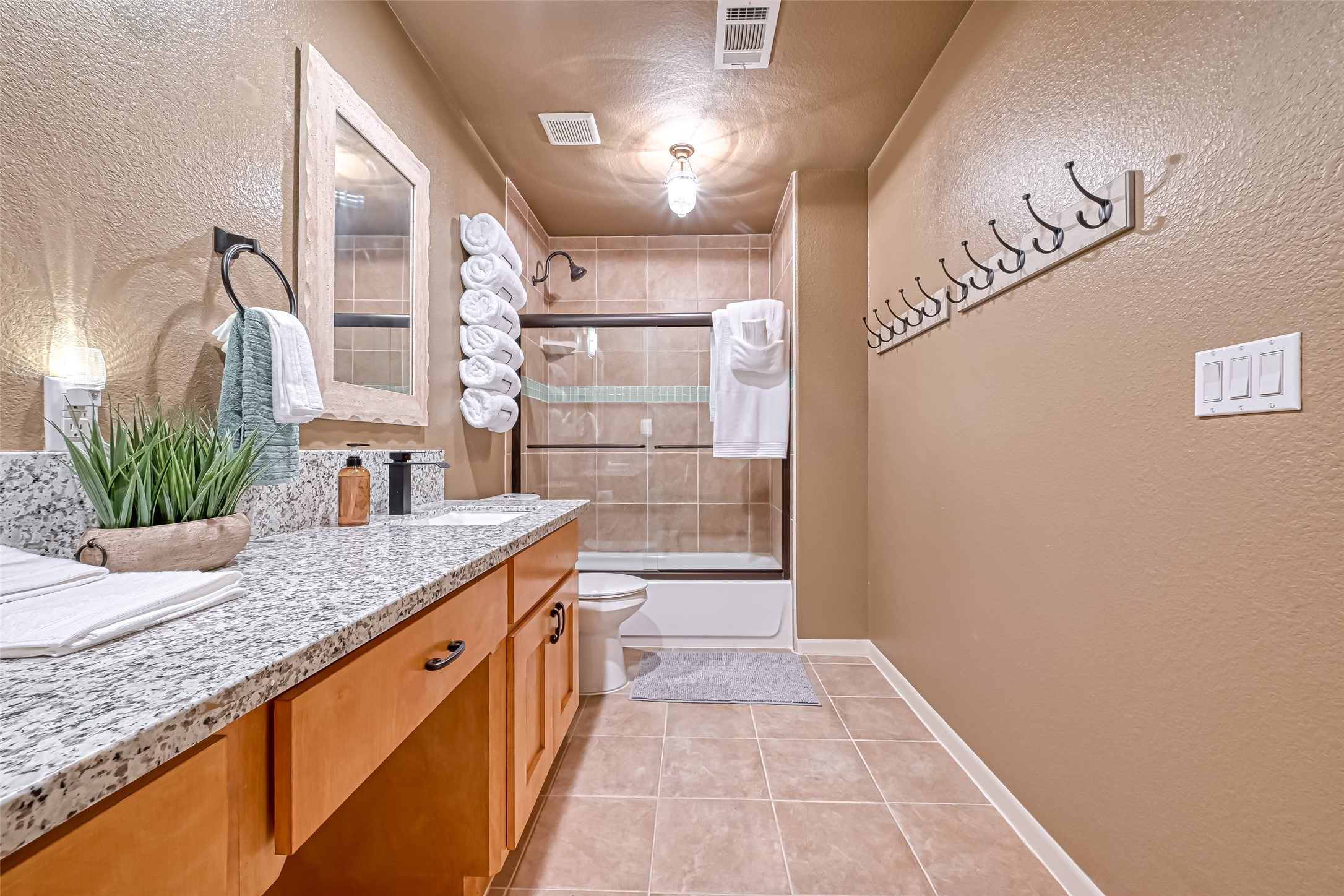 2102 Todville Road, Unit 9 Seabrook, TX 77586 - Photo 25 of 45 a bathroom with a granite countertop sink a mirror and shower