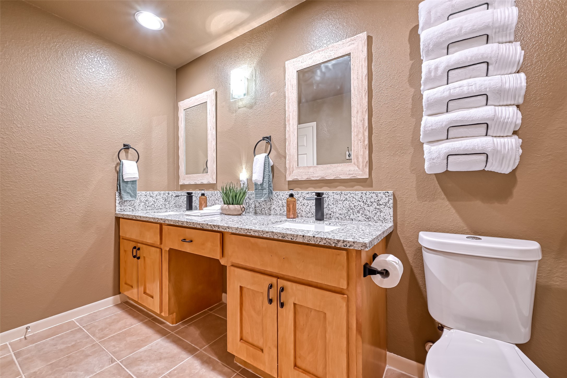 2102 Todville Road, Unit 9 Seabrook, TX 77586 - Photo 26 of 45 a bathroom with a granite countertop toilet sink and mirror
