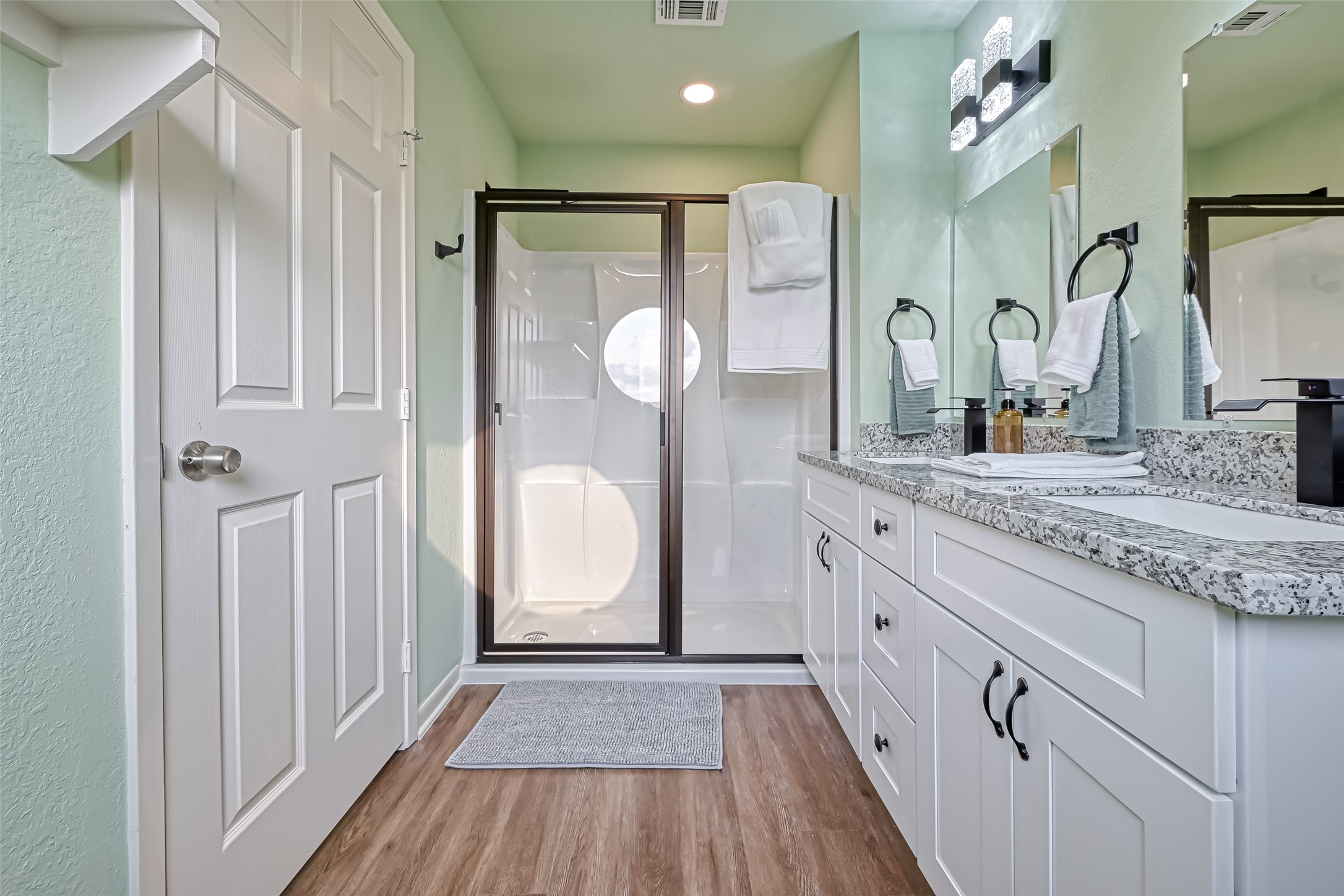 2102 Todville Road, Unit 9 Seabrook, TX 77586 - Photo 31 of 45 a bathroom with a granite countertop sink vanity mirror and shower