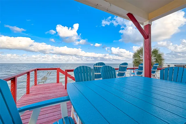 a view of a balcony with dining table