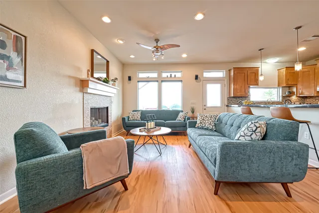 a living room with fireplace furniture and a wooden floor