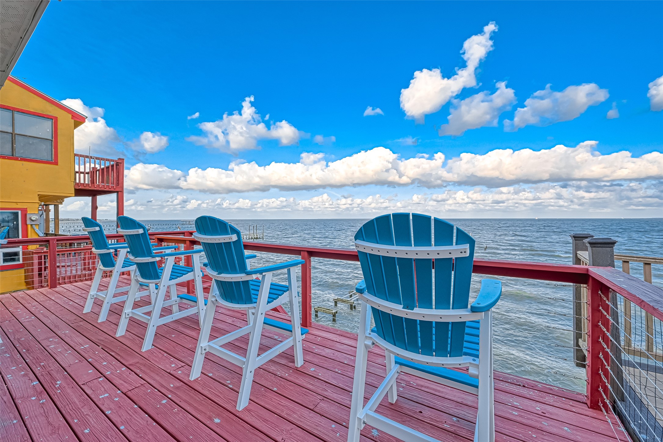 2102 Todville Road, Unit 9 Seabrook, TX 77586 - Photo 44 of 45 a view of a roof deck with table and chairs with wooden floor