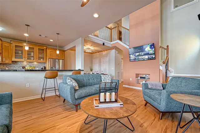 a living room with furniture and a wooden floor