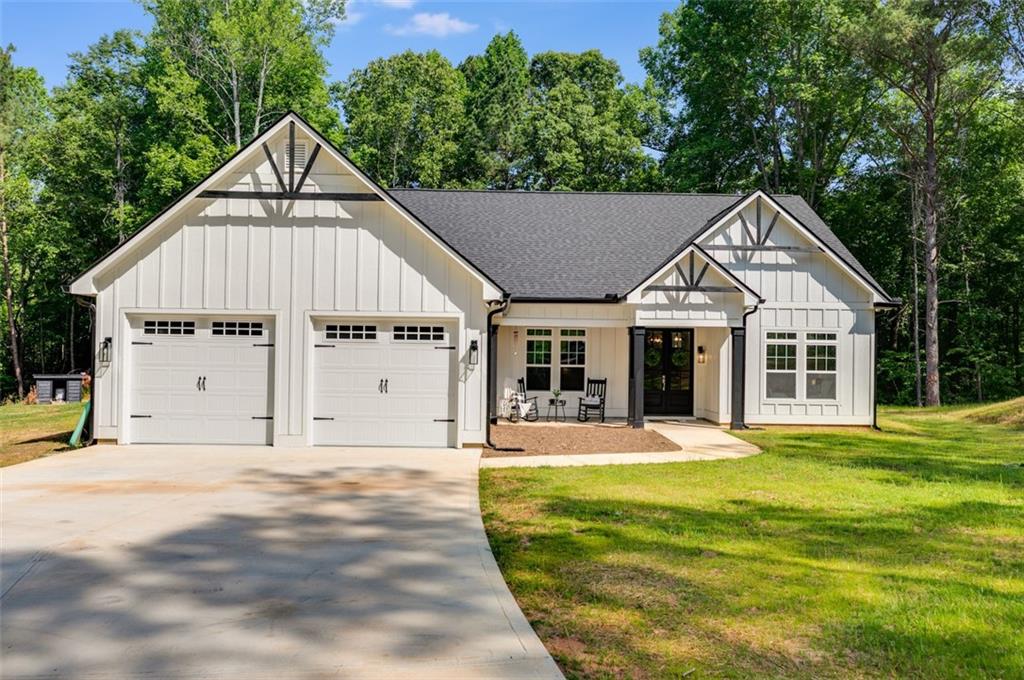 490 Happy Hollow Road Villa Rica, GA 30180 - Photo 1 of 1 a view of a white house with a big yard and potted plants