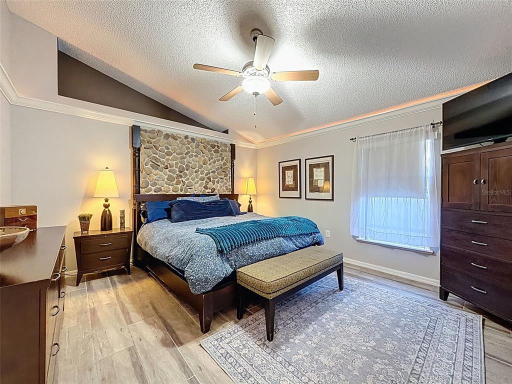5407 Treig Lane Wesley Chapel, FL 33545 - Photo 27 of 70 a bedroom with a bed and a dresser