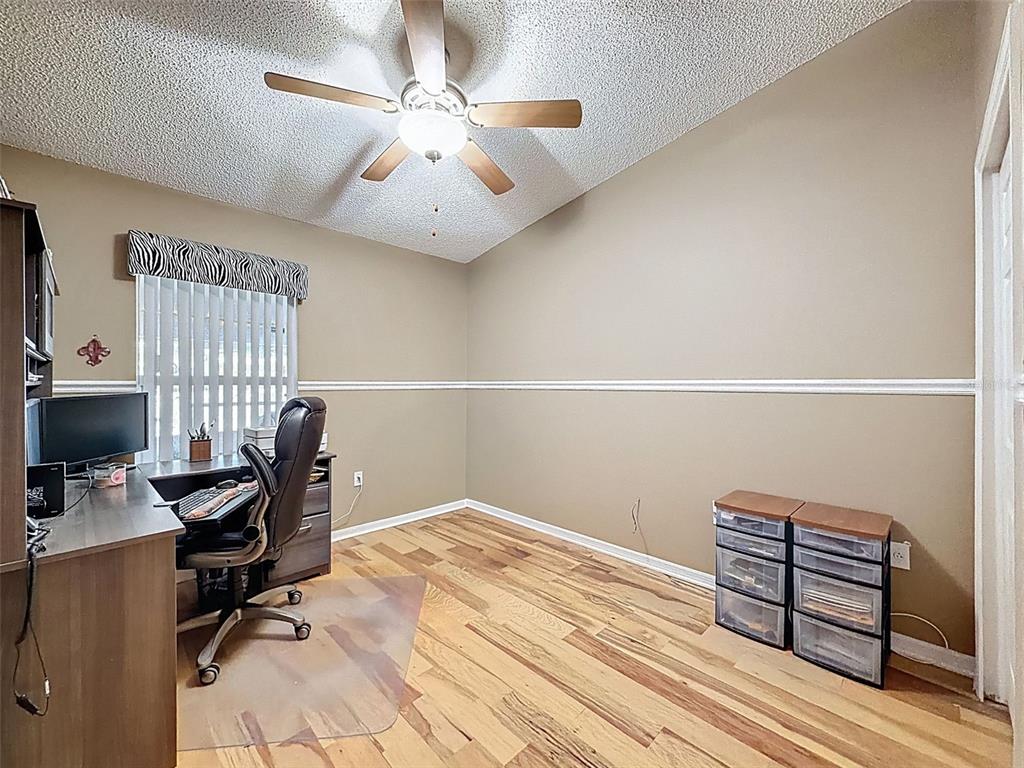 5407 Treig Lane Wesley Chapel, FL 33545 - Photo 38 of 70 a view of a workspace with furniture and a ceiling fan