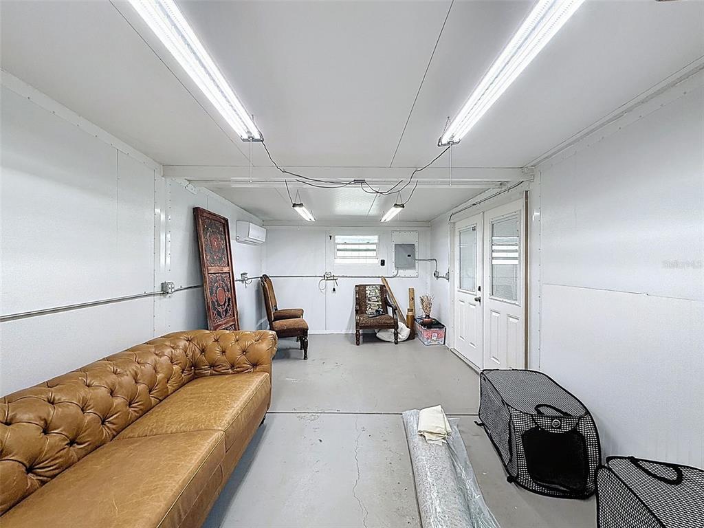 5407 Treig Lane Wesley Chapel, FL 33545 - Photo 47 of 70 a living room with furniture a couch and a ceiling fan