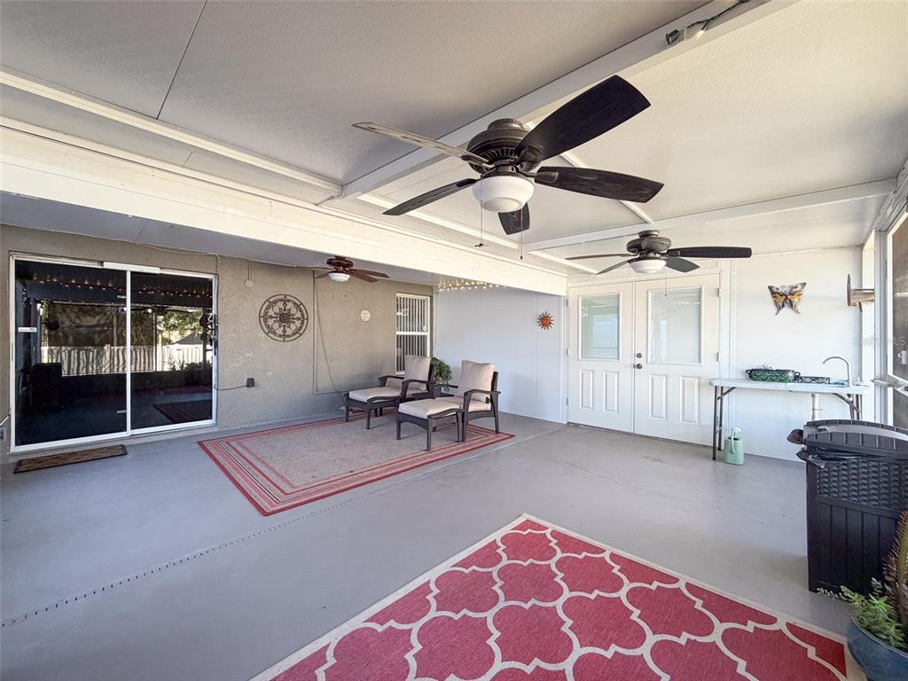 5407 Treig Lane Wesley Chapel, FL 33545 - Photo 51 of 70 a view of a livingroom with furniture and a ceiling fan