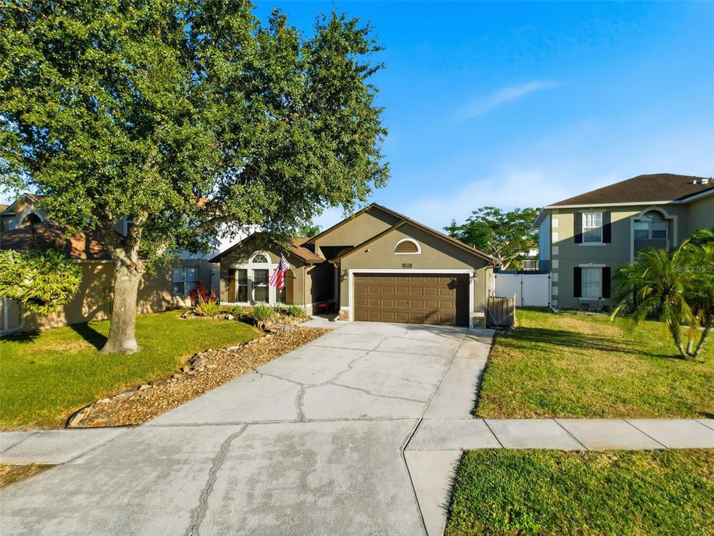 5407 Treig Lane Wesley Chapel, FL 33545 - Photo 68 of 70 a front view of a house with a yard and garage