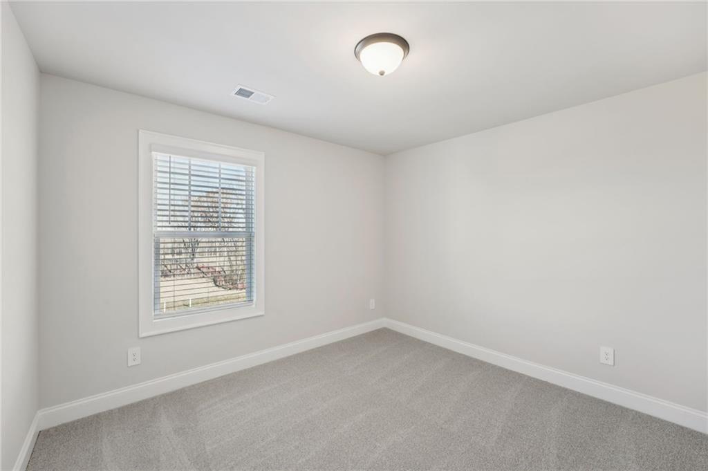 6440 Pinin Place Cumming, GA 30041 - Photo 29 of 52 an empty room with a window
