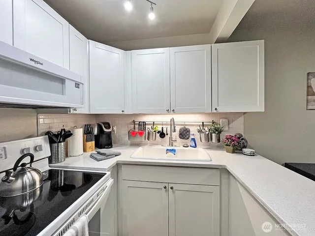 a kitchen with a sink cabinets and appliances