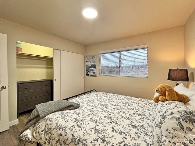 a bedroom with a bed and a window