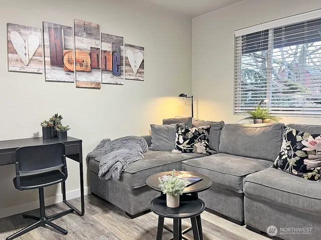 a living room with furniture and a large window