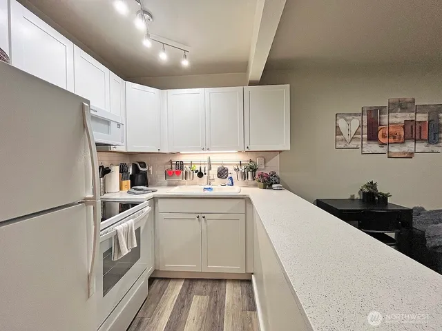 a kitchen with a white cabinets and white appliances