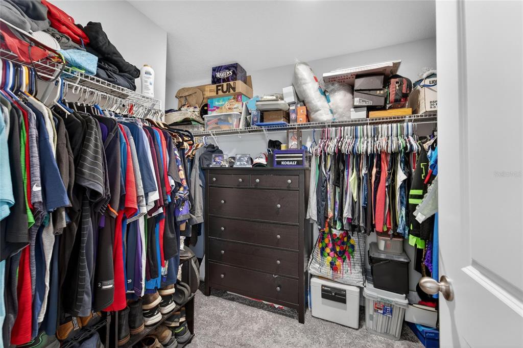 10908 Quickwater Court Riverview, FL 33569 - Photo 20 of 35 a view of walk in closet with clothes and shoes