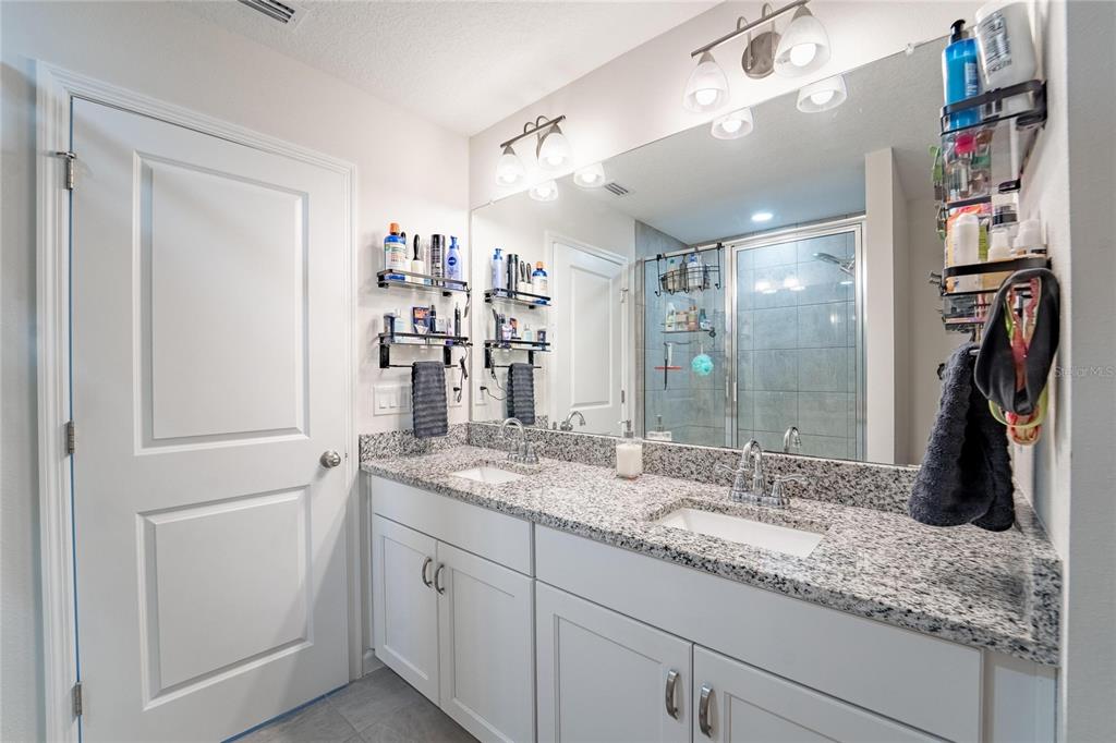 10908 Quickwater Court Riverview, FL 33569 - Photo 22 of 35 a bathroom with a granite countertop sink and a mirror