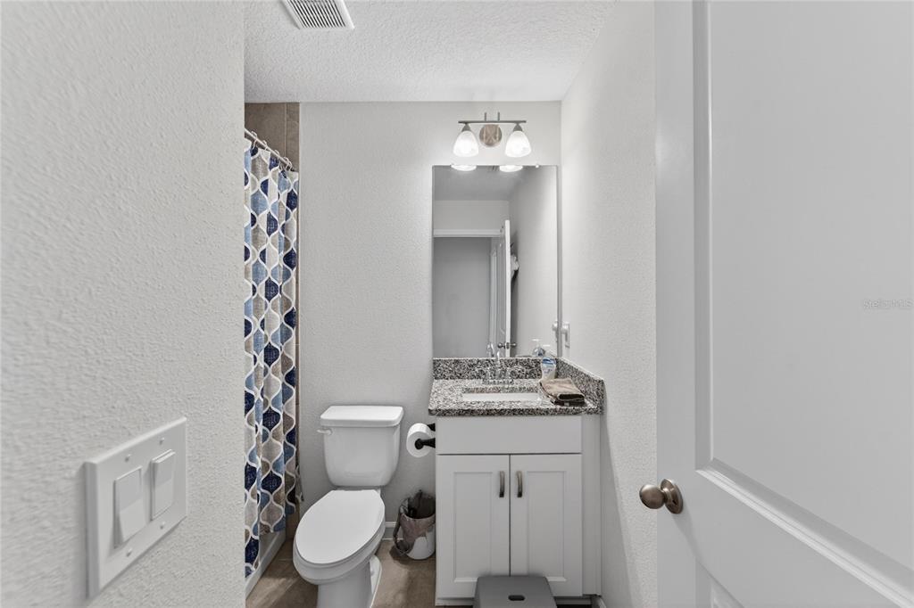 10908 Quickwater Court Riverview, FL 33569 - Photo 28 of 35 a bathroom with a toilet a sink and a mirror