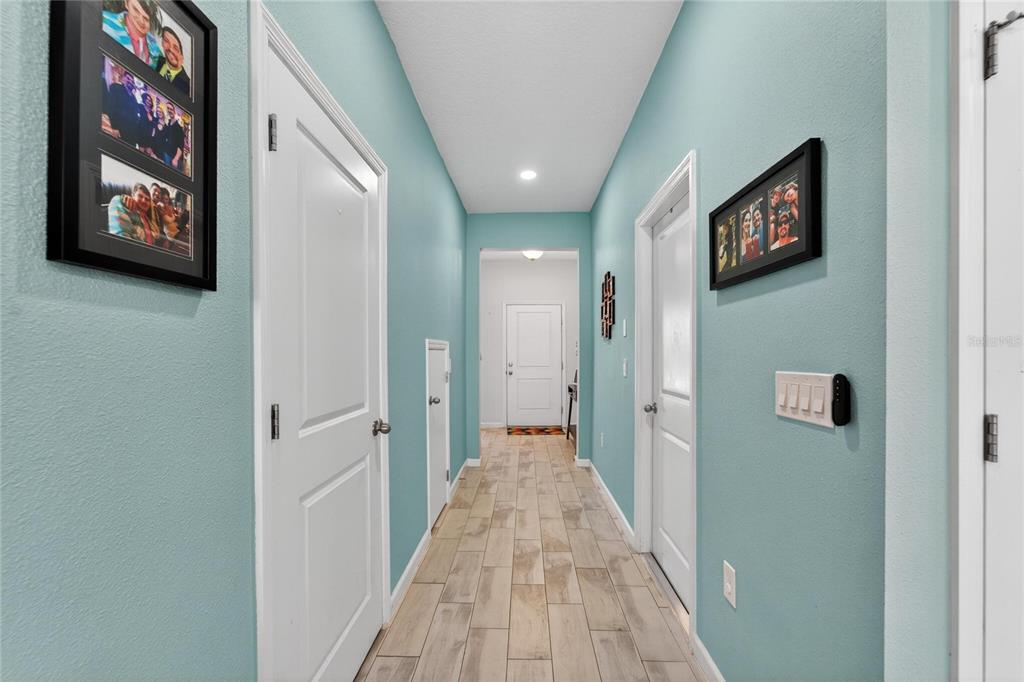 10908 Quickwater Court Riverview, FL 33569 - Photo 6 of 35 a view of a hallway with paintings on the wall