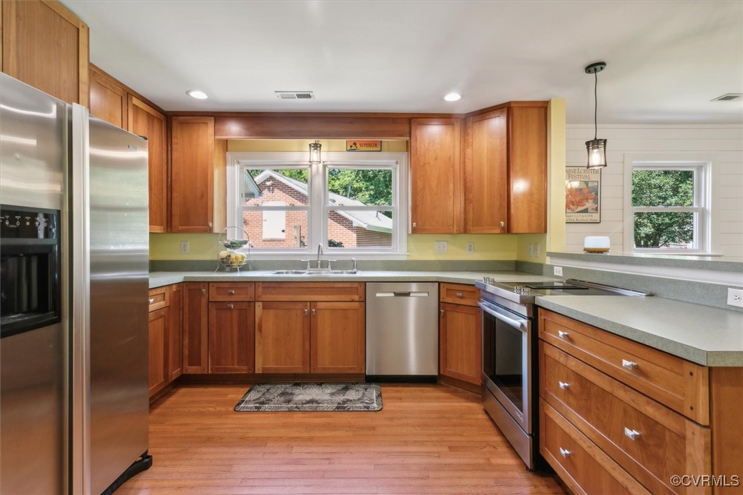 3124 North Riverside Drive Lanexa, VA 23089 - Photo 15 of 50 a kitchen with stainless steel appliances granite countertop wooden cabinets a refrigerator and a sink