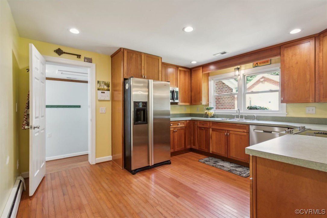 3124 North Riverside Drive Lanexa, VA 23089 - Photo 16 of 50 a kitchen with stainless steel appliances granite countertop a refrigerator a sink dishwasher a stove with wooden floors and cabinets
