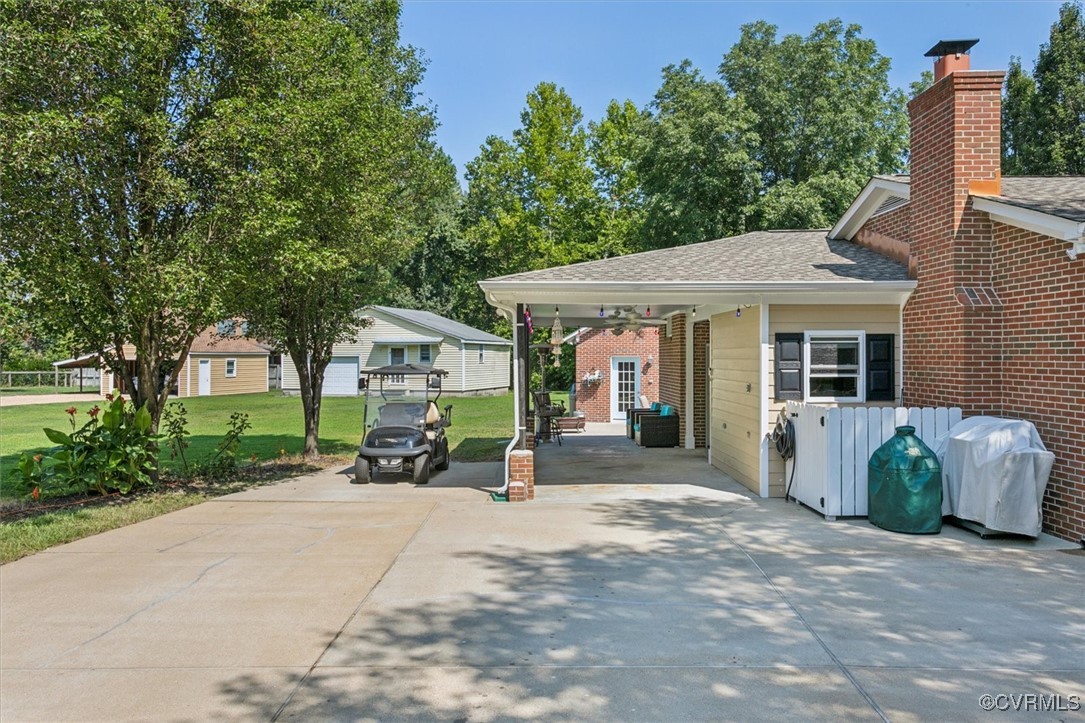 3124 North Riverside Drive Lanexa, VA 23089 - Photo 32 of 50 a front view of a house with a garden and trees