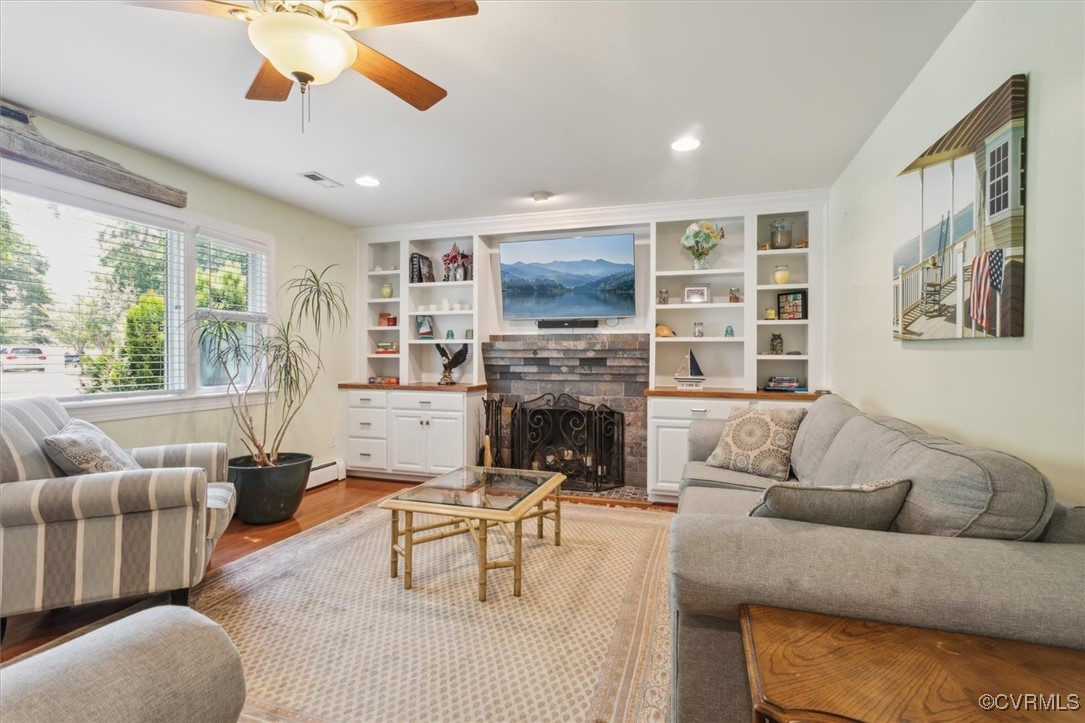 3124 North Riverside Drive Lanexa, VA 23089 - Photo 9 of 50 a living room with furniture a fireplace and a flat screen tv