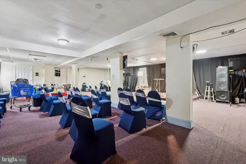 a living room with furniture a large window and kitchen view