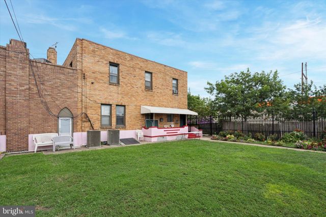 a front view of house with yard and outdoor seating