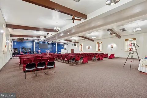 a room with furniture pool table and windows