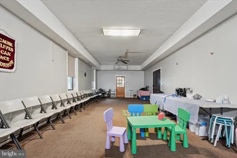 a kitchen with granite countertop a sink a counter top space stainless steel appliances and cabinets