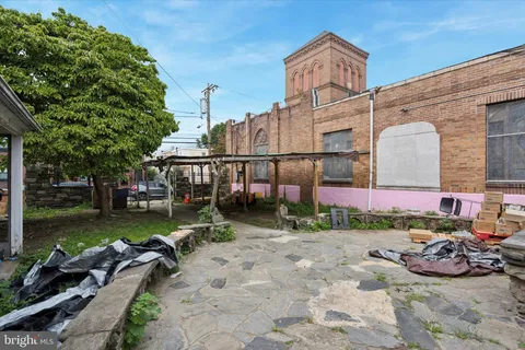 a backyard of a house with lots of green space and fountain