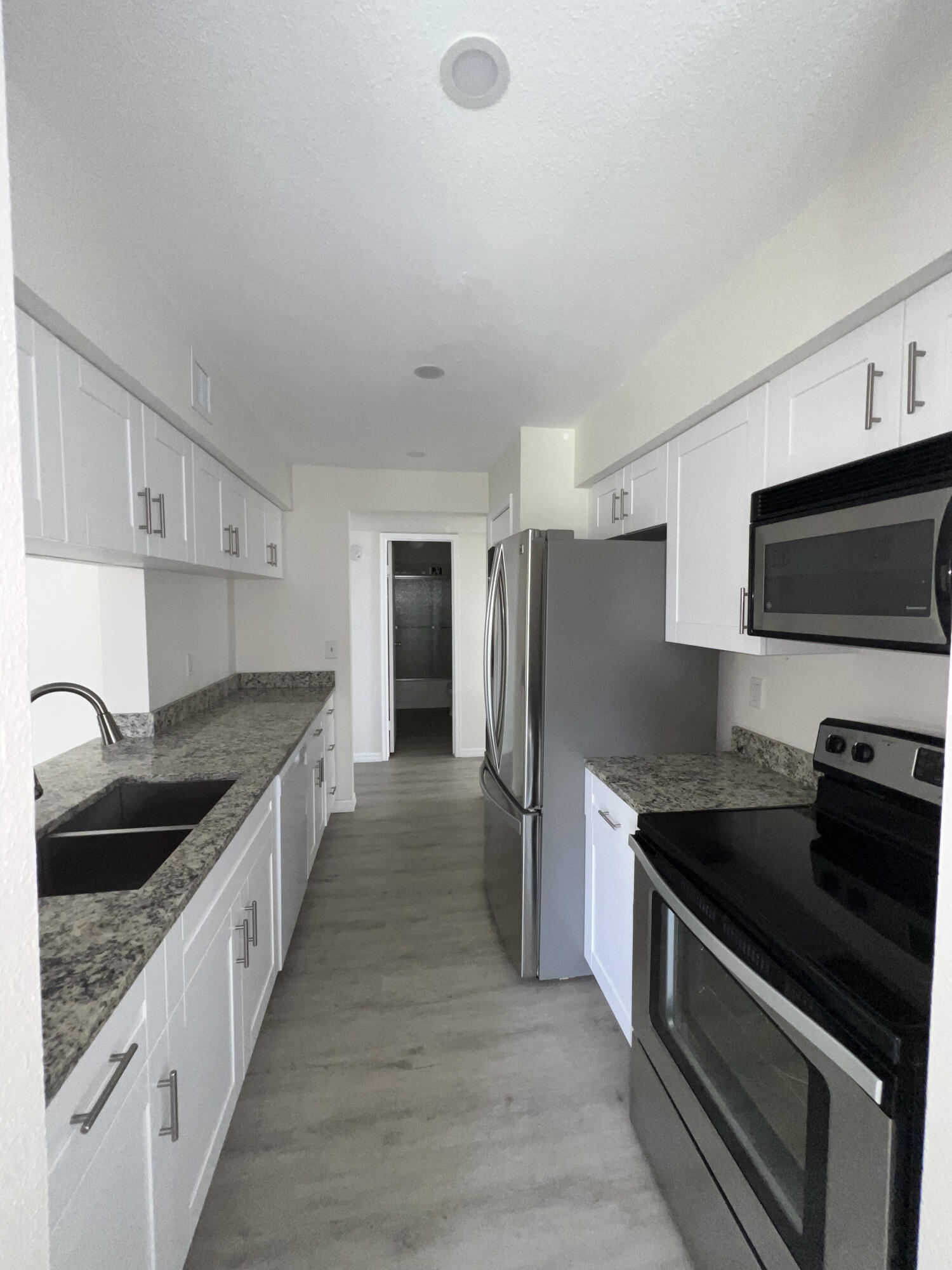 899 Riverside Drive, Unit 620 Coral Springs, FL 33071 - Photo 12 of 46 a kitchen with stainless steel appliances granite countertop a sink stove and refrigerator