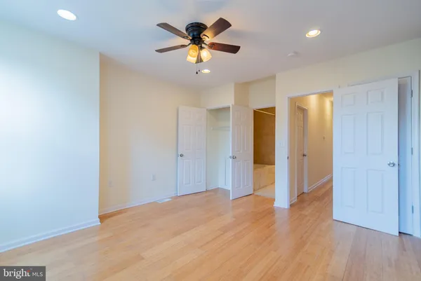 a view of an empty room with a ceiling fan