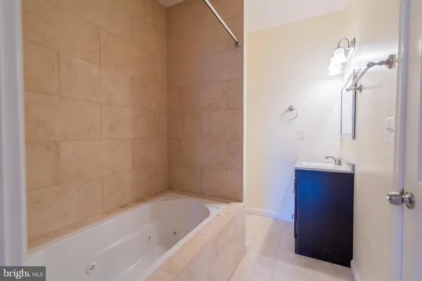 a bathroom with a bathtub and shower