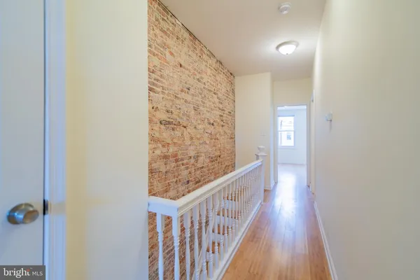 a view of hallway with wooden floor