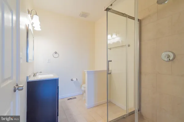 a bathroom with a shower and a sink