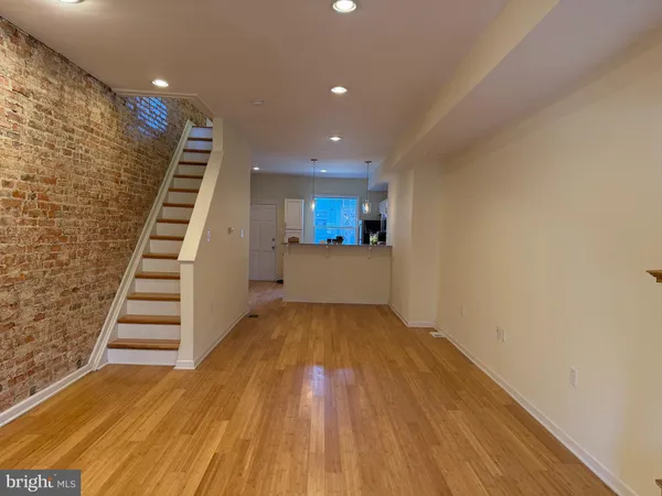 a view of a room with wooden floor and stairs