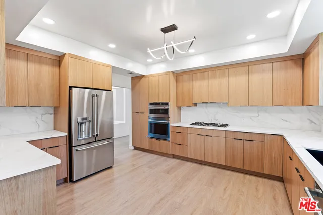 a kitchen with granite countertop a refrigerator oven a sink and dishwasher